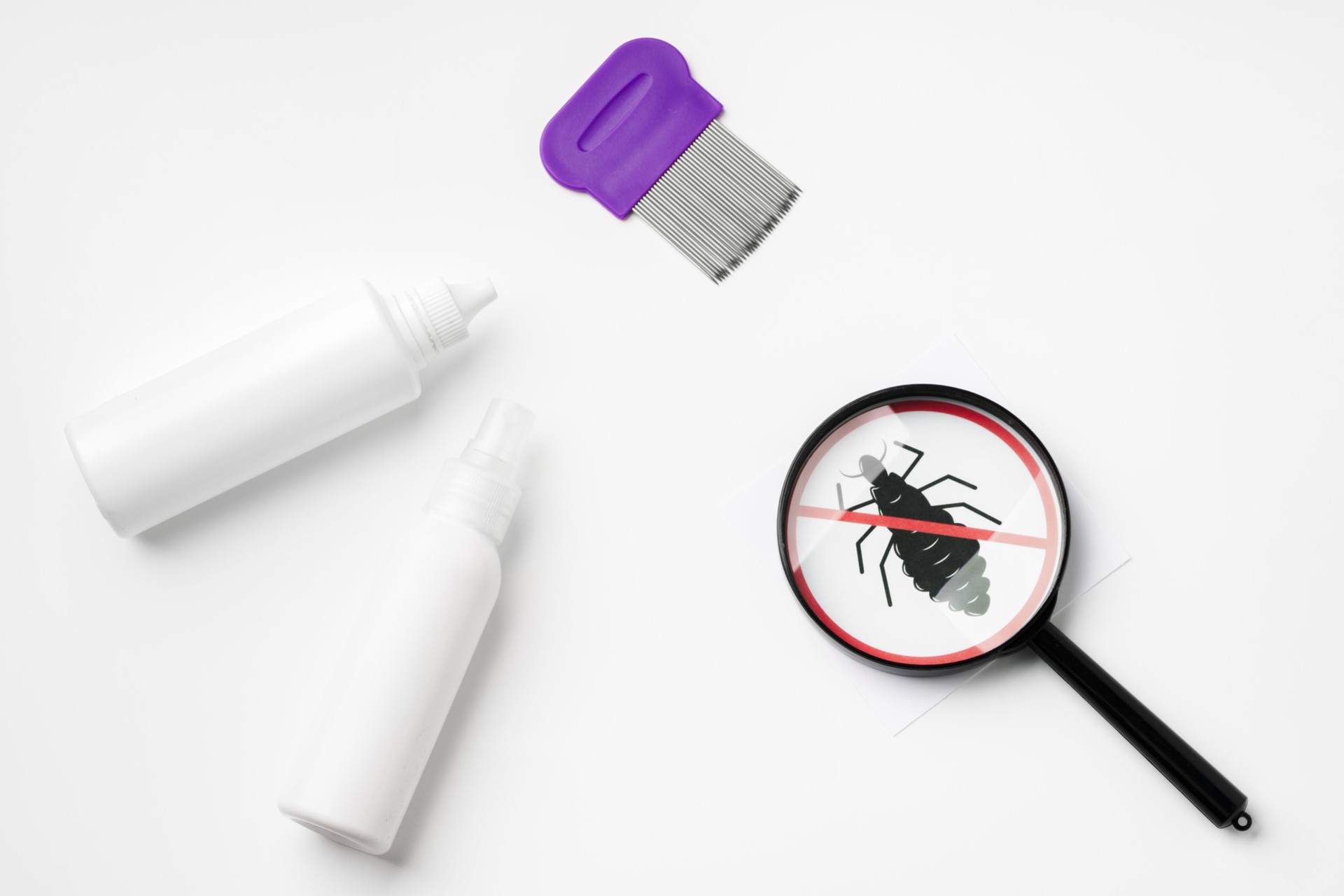 Tools for inspecting and treating lice infestations at home with a magnifying glass and a comb